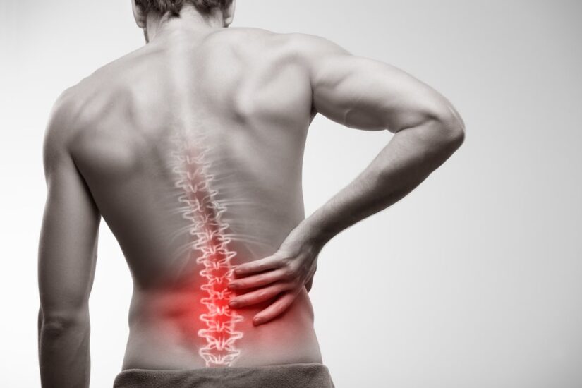 Black And White Photo Of A Mans Back With Red Colour Over His Lower Back