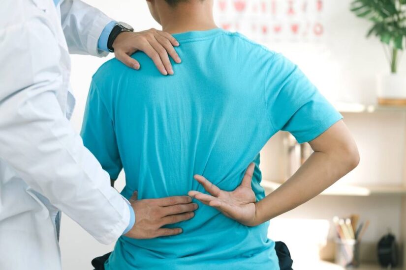 Photo of a Doctor Diagnosing Back Pain